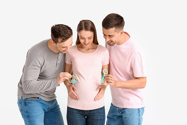 photo of a gay couple with pregnant woman